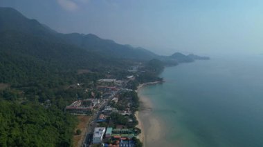 Koh Chang köyünün hava manzarası verimli tropikal ormanlar ve plaj otellerini yüzme havuzlarıyla ayırıyor. Yukarıdan insansız hava aracı görüntüleri 