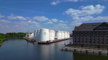 Berlin Westhafen endüstriyel limanının arka planında yakıt depolama tankları, kargo konteynerleri ve Berlin şehir manzarası var. hız rampası hiper hareket zaman aşımı 