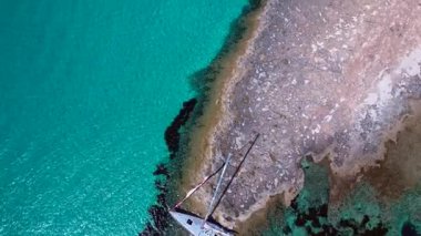 Yelkenli, güneşli bir yaz gününde İspanya 'nın Formentera Adası kıyılarında mahsur kaldı. Drone 'u yukarı eğ 
