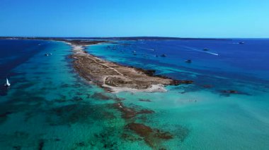 Punta des Borronar plajı Formentera adasında, yatları turkuaz sularla dolu. Yukarıdan drone atışı 