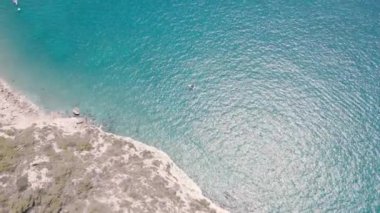 4k Aerial drone video in calm sea surface. Boat in the middle of the blue sea. High quality 4k footage