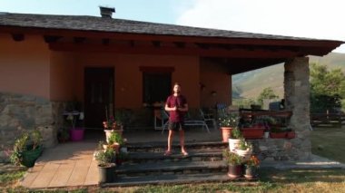 4k, aerial view of look-up shoot of house in the village in the middle of the nature. Drone pilot in the house