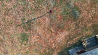 4k, aerial view of look-up shoot or head-over of house in plot in the middle of the nature. 1 person in the middle
