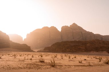 Jordan, Wadi Rum çölünde Sand Dune ve Amazing Rock 'ın günbatımı sahnesi. Seyahat yerleri. Mars manzarası