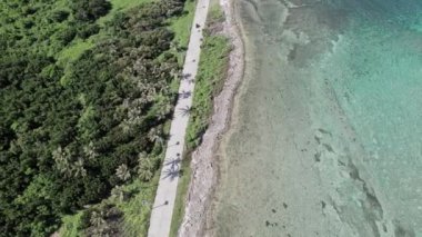 Karayip Denizi 'nin kıyısındaki bir yol boyunca giden bazı arabaların hava aracı videoları. San Andres Adası, Kolombiya