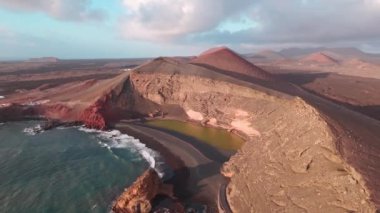 Charco Verde veya Chaco de los Clicos of Lanzarote 'nin çarpıcı uçurumlarının insansız hava aracı görüntüsü güzellikleri ve volkanik tarihi gözler önüne seriyor..