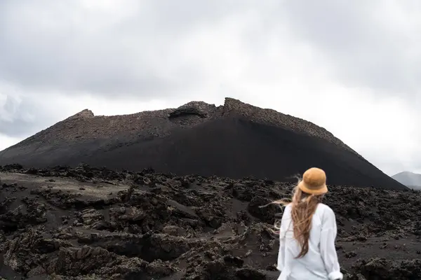 El Cuervo volkanik manzarası Lanzarote 'de gün doğumunda gün ışığıyla ışıldayan kadın görüntüsü.