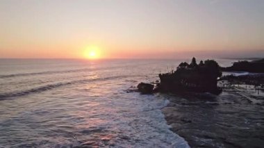 Altın gün batımı, Tanah çok tapınağını aydınlatıyor. Endonezya, Bali 'de kayalık bir çıkıntıya tünemiş önemli bir Hindu hac alanı.