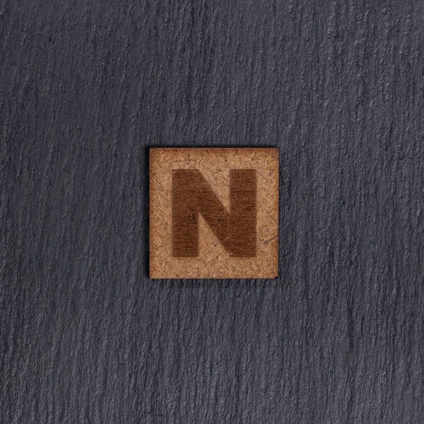 Square Wooden Tiles Letter Black Stone Background — 스톡 사진