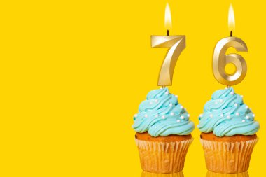 Doğum günü pastaları ve mumlar yakılıyor. 76 Numaralı Fotoğraf Sarı Arkaplanda.