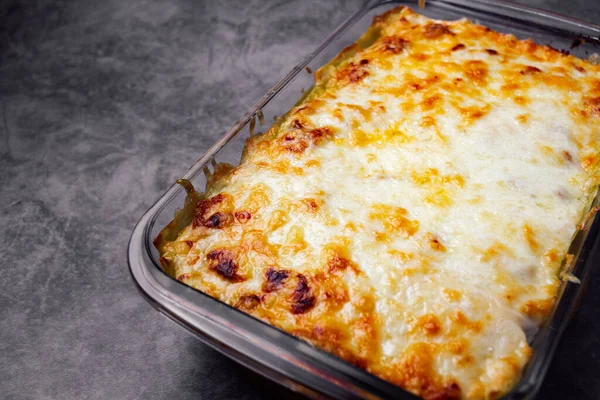 Horizontal photo of traditional italian lasagna with copy space. Close up of delicious and freshly baked homemade lasagna isolated and with copy space.