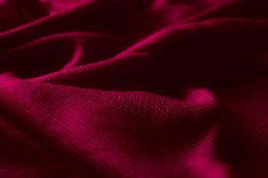 Fabric texture background of magenta color (Viva Magenta). Close up of clothes as wallpaper.