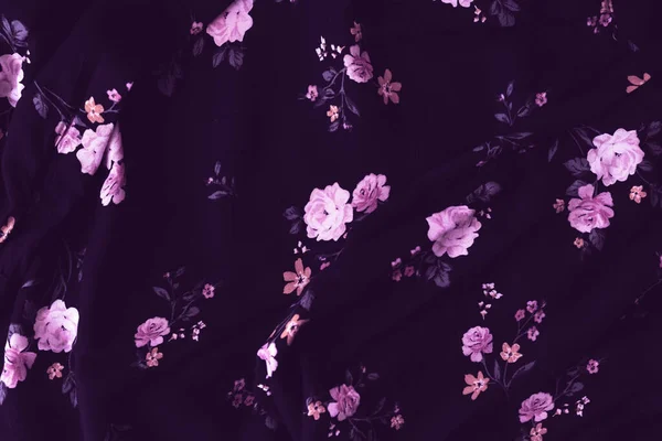 Dark pink flower cloth pattern for background and with copy space. Beautiful floral design on dark blouse textured. Vintage design. Close up photo.