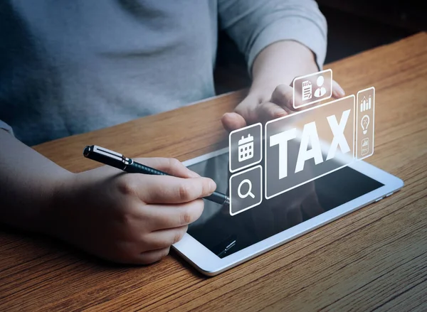 Woman use digital tablet to calculate tax reduction. Tax deduction planning concept. Income tax and property tax. Mortgage interest and business expenses.
