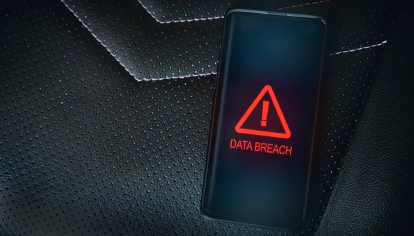 Top view photo of smartphone with system warning alert on screen. Compromised information concept. Data breach. Malicious software. Virus crime. Data vulnerability.