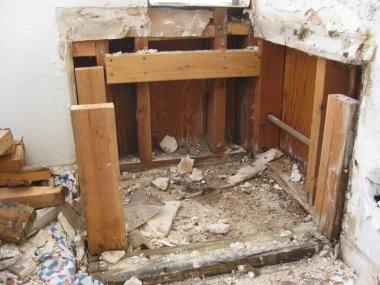 Demo of Old Water Heater Stand Drywall and 2x4s. High quality photo