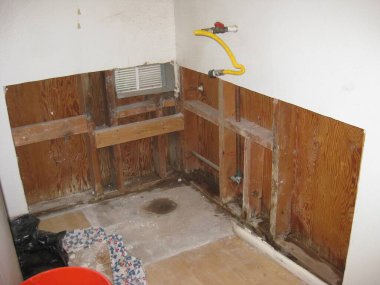 Demo of Old Water Heater Stand Complete, Open Drywall . High quality photo