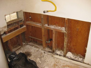 Demo of Old Water Heater Stand, Now Open Drywall . High quality photo