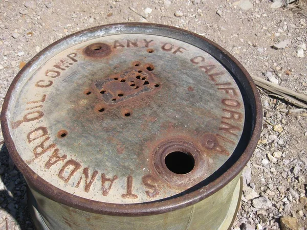 Top of Green Rusty Old Oil Drum Barrel in Desert . High quality photo