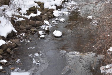 Snowy Rocks in Icy River, Winter in Minnesota. High quality photo