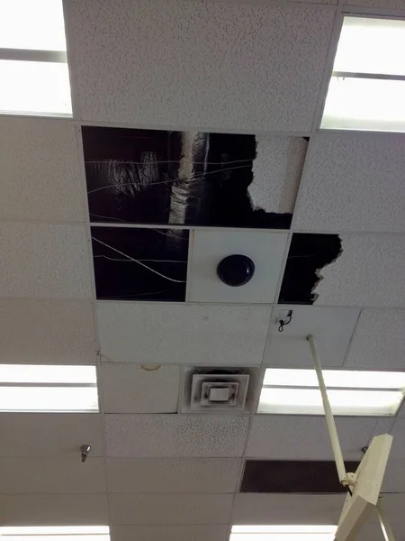 Damaged Ceiling Tiles in Commercial Building After Rain. High quality photo