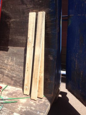 Three Wooden 2x4s in a Construction Dumpster. High quality photo clipart