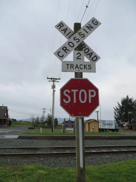 Railroad Crossing Stop Sign by Two Tracks . High quality photo