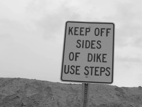 Keep Off Sides of Dike Use Steps Sign in California . High quality photo