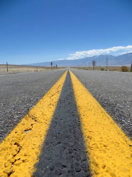 Solid Yellow Lines on Lonely Desert Highway . High quality photo