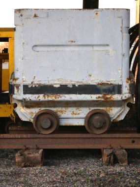 Old rusty coal transport cart on rails