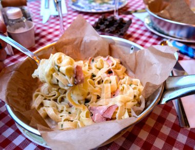 Carbonara tagliatelle,ready to eat, directly in an inox pan.