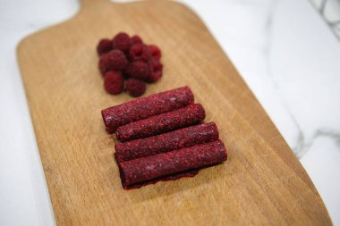 Preparation of a fruit leather, from blended and dehydrated raspberries. clipart