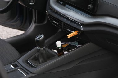 Installation of a clothespin on a car interior vent, impregnated with essential oil. To detoxify and remove unpleasant odours. clipart