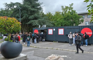 Villeneuve d'Ascq, France - 09 16 2024 : Students queuing in front of a crous food truck at the University of Lille. clipart