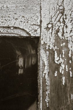 Eski bir ahşap atölye kapısının ayrıntıları, boyaların soyulduğu (bir fotoğraf serisinin parçası)).