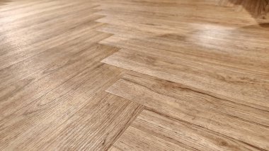 Close-up of a wooden floor, laid in a herringbone pattern. clipart