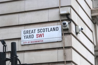 London, United Kingdom - 11 10 2024 : Great Scotland Yard street sign on a wall. Two surveillance cameras are located nearby. clipart