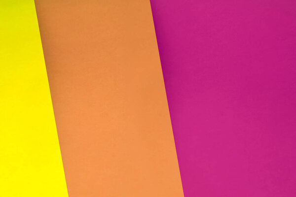 colored sheets of paper on a pink background