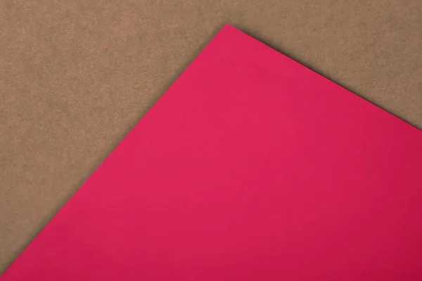 Stock image pink paper on red paper background. top view. copy space 