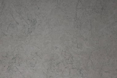 Çatlakları ve çizikleri olan beton bir duvarın dokusu arka plan olarak kullanılabilir.