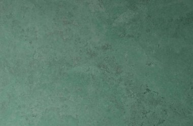 Arkaplanda çatlaklar ve çizikler olan yeşil bir duvarın dokusu