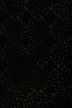 Siyah bir arkaplanda siyah dantelin kusursuz deseni