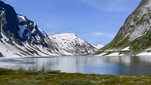 stock image Fjord lake in snow capped mountain landscape, travel Norway on bright summer day