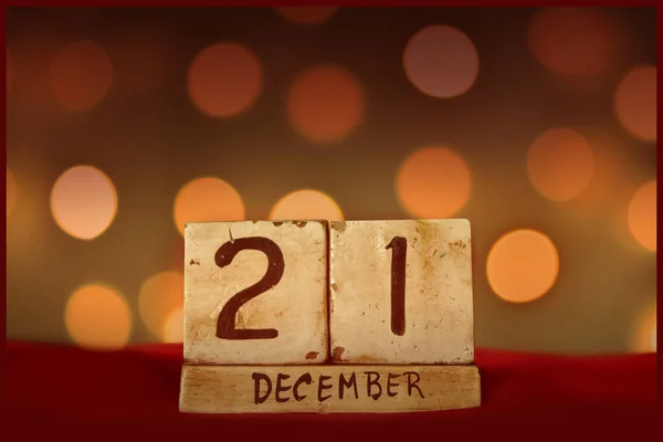 December 21 vintage wooden block calendar festive bokeh lights background