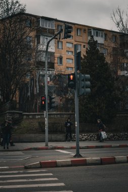 pedestrian crosswalk traffic light dark with buildings in background. High quality photo