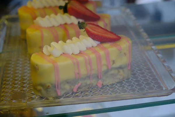 close up of patisserie mini cakes in cupboard
