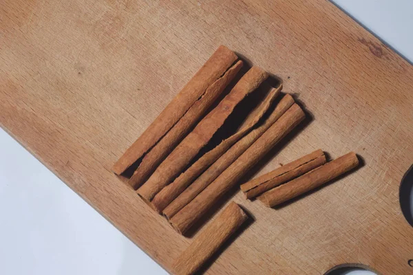 cinnamon sticks on wooden board in macro shot