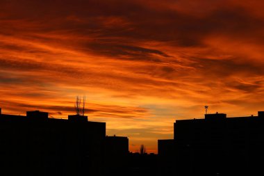 Sunset in the city with the silhouette of panel houses