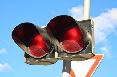 İki kırmızı ışığı olan trafik ışığı. Değişen yanıp sönen ışıkların ışığı sürücünün aracı durdurması gerektiği anlamına gelir.