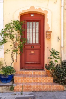 Arles, Bouches-du-Rhone, Provence-Alpes-Cote d'Azur, France. Red door on a home in Arles.